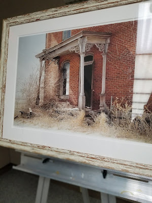 painting of home covered in weeds